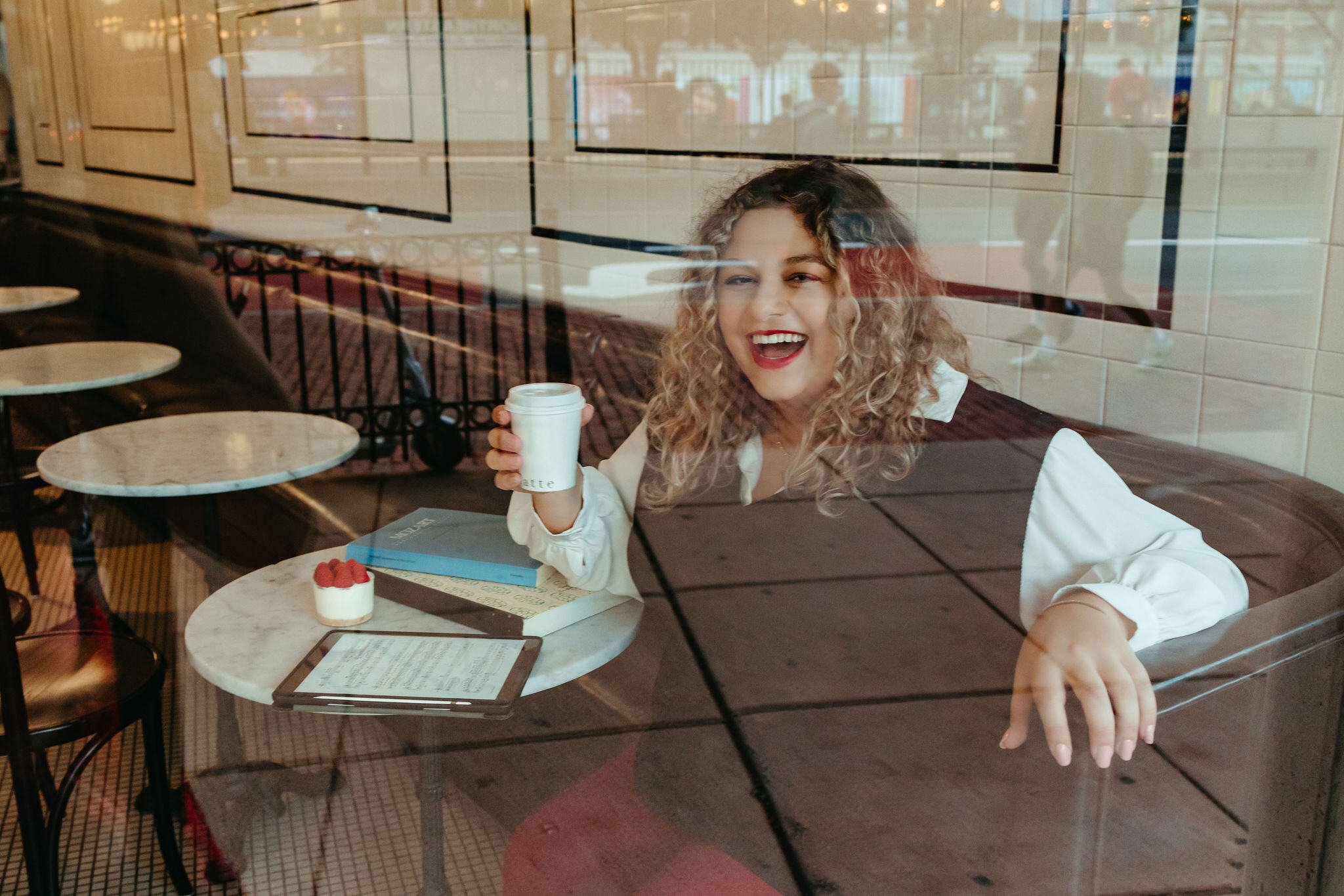 Musician portrait for a mezzo soprano with a music and a Mozart score in a coffee shop.