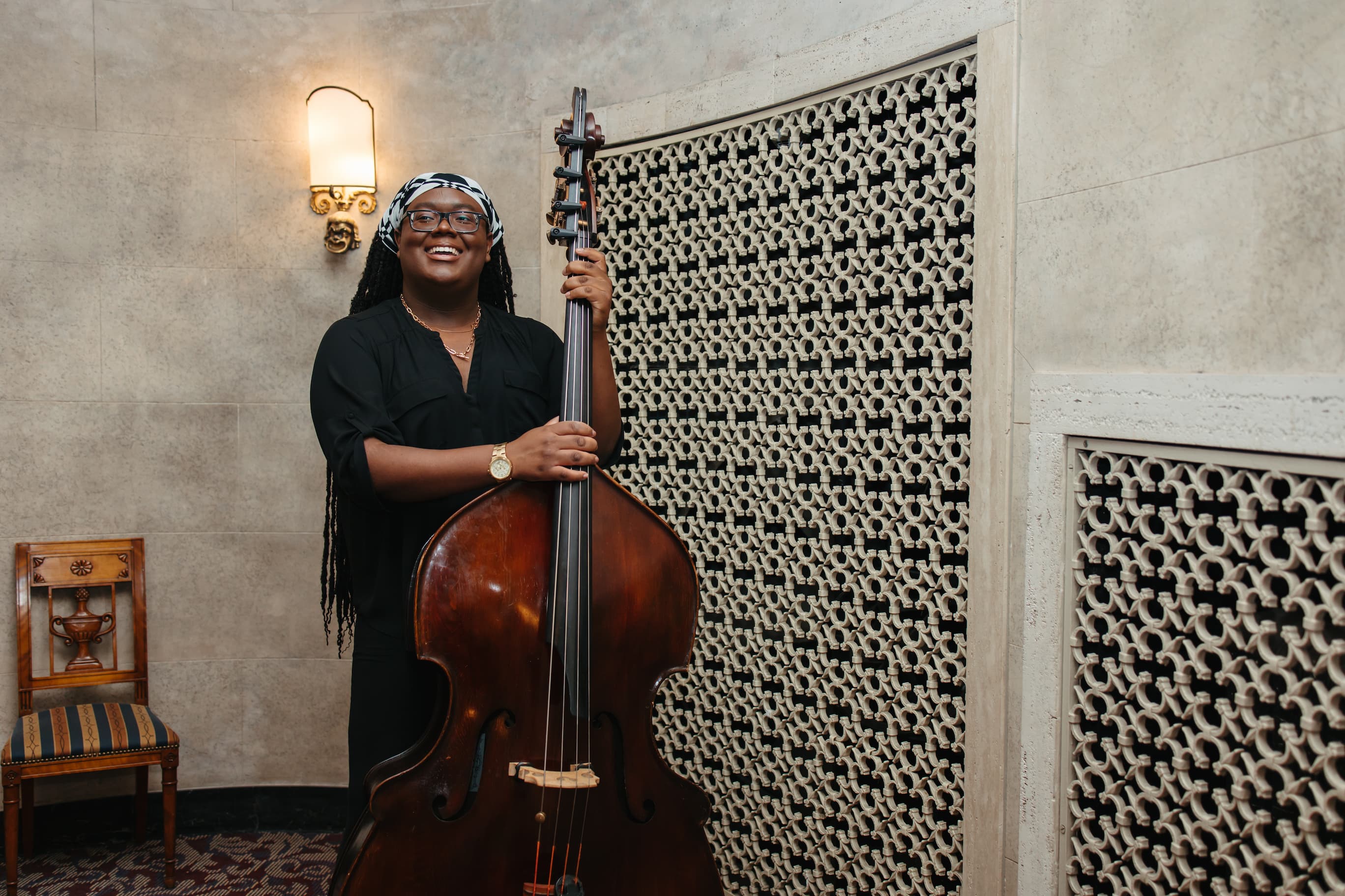 Musician portrait of a double bass player with their instrument.